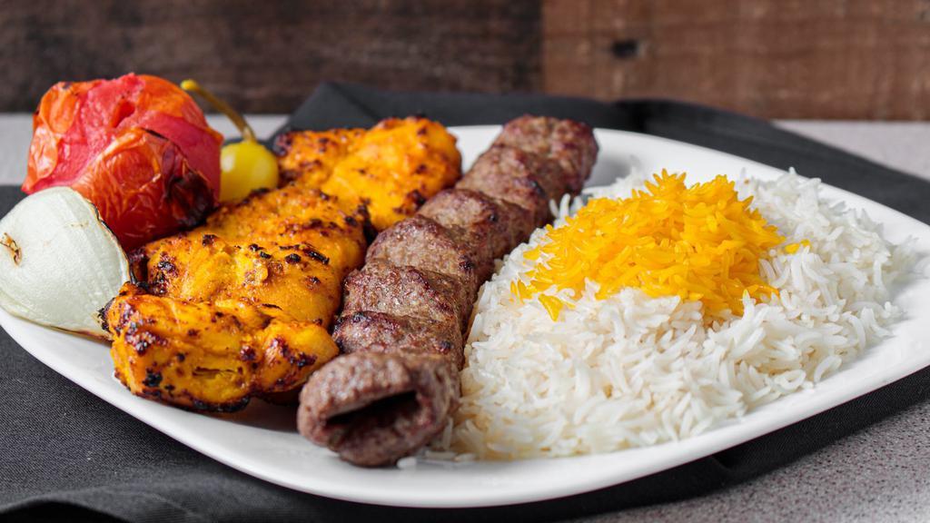 The Combo (1 Beef 1 Chicken) · Skewers of char-broiled chicken breast tender and a ground beef kabob sitting on top of white basmati rice topped with saffron, accompanied by a grilled tomato, onion, and covered by a pita bread. Gluten-Free