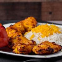 Chicken Breast Kabob · Enjoy skewers of a marinated chicken breast with warm basmati rice and grilled onions, green...