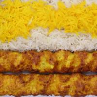Ground Chicken Kabob ( Koobideh ) · 2 skewers of charbroiled ground chicken breast  sitting on top of white basmati rice topped ...