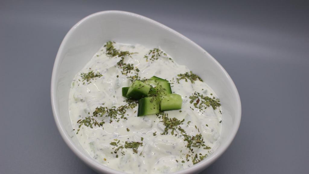 Yogurt With Cucumbers · Cucumbers, dried mint, salt, and white pepper mixed with thick yogurt. Vegetarian, Gluten-Free