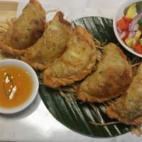 Curry Puff Chicken · Chicken, curry powder, potatoes and onions in deep fried pastry shell.