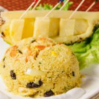Pineapple Fried Rice · Fried rice with shrimps, chicken, pineapple, cashew nut, onions, raisin and egg, seasoned an...