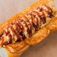 Cowboy Haus Dogs · Smoked bacon dog, Cheddar cheese sauce, crispy onions, and BBQ sauce on a king's Hawaiian ro...
