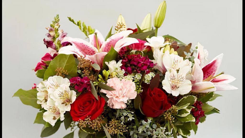 Date Night On The Town · This arrangement of roses, stargazer lilies, carnations, and alstroemeria's is a delightful representation of love at first sight.