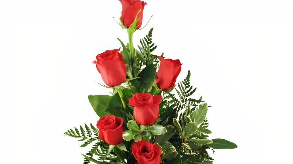 6 Red Roses · What's sweeter than sugar and quicker than cupid's arrow? The red rose is a timeless expression of romance and passion - without saying a single word.
six beautiful red roses are nestled among decorative greens.