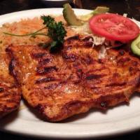 Cancun Chicken · Grilled boneless chicken breast served with rice, sliced avocado, tomatoes, sweet corn cake,...