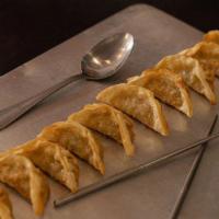 Pot Stickers 10 · Pan fried chicken dumplings filled with green onions.