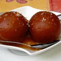 Gulub Jaman · Fried dough ball in a sweet syrup of honey and rosewater.