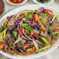 Jap Che / 잡채 · Sweet potato noodles, stir fried in sesame oil with various vegetables.