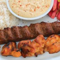 # 11 Combo Kabob · Marinated chicken, Ground steak, rice, tomatoes, spiced onions, hummus, pickled turnips.