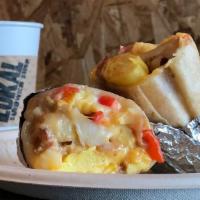 Breakfast Burrito · Bacon, egg, Mexican crema, Jack cheese, Cheddar cheese, potatoes, red bell pepper, flour tor...