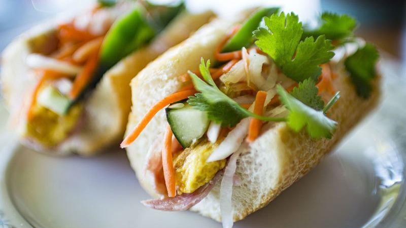 Banh Mi Breakfast · Vietnamese ham, eggs, pork pate, cucumber, housemade pickled daikon, and carrots, jalapeño, mayo and cilantro on toasted baguette.