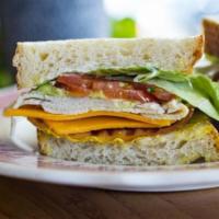 Tblt · Turkey, bacon, lettuce, tomatoes, avocado, mayo, mustard, and cheddar on toasted rustic sour...