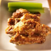 Garlic Parmesan Wings · Golden & crispy fried wings glazed with a cheesy garlic parmesan sauce.