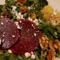 Beet Salad · Beets, candied apple, caramelized walnuts, and goat cheese over arugula tossed in our roaste...