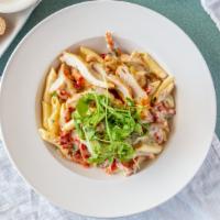 Pasta Milano · Sun-dried tomatoes, scallions and mushrooms in a creamy roasted garlic sauce with sliced cri...