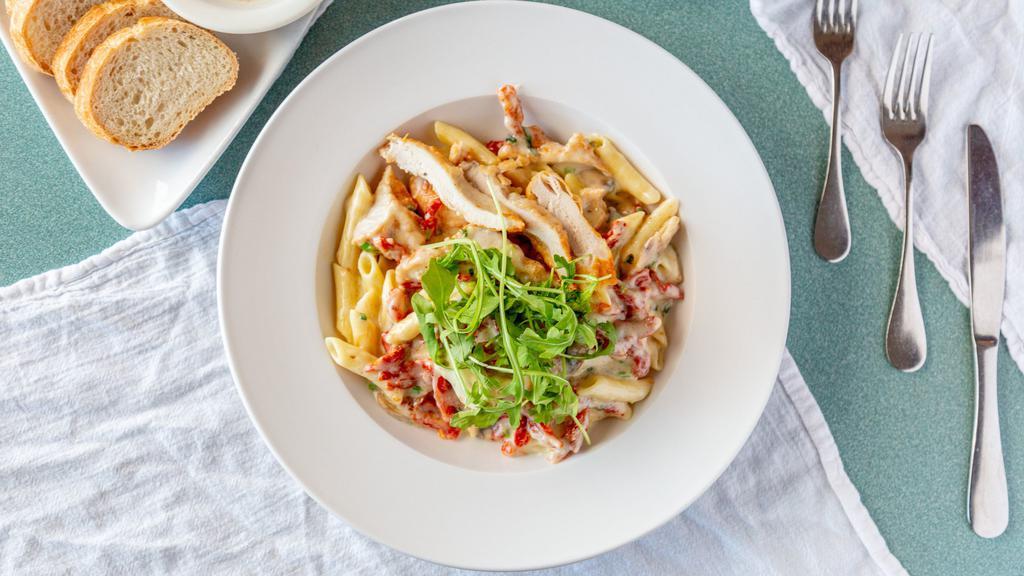 Pasta Milano · Sun-dried tomatoes, scallions and mushrooms in a creamy roasted garlic sauce with sliced crispy chicken breast.