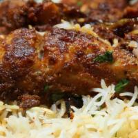 Chicken Biryani · Basmati rice cooked with chicken and spices with a hint of saffron.