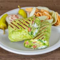 Hummus Wrap · Hummus spread, feta cheese, tomatoes, cucumbers, avocado, and romaine lettuce wrapped in a t...