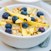 Steel Cut Oatmeal · Fresh blueberries, mango, & toasted macadamia nuts.  Served with milk & brown sugar on the s...