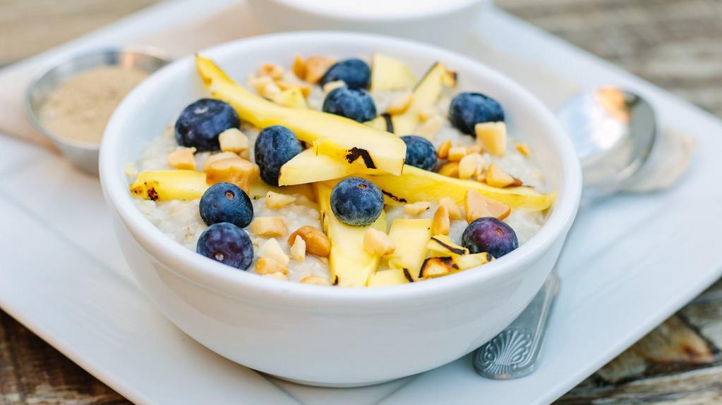 Steel Cut Oatmeal · Fresh blueberries, mango, & toasted macadamia nuts.  Served with milk & brown sugar on the side.