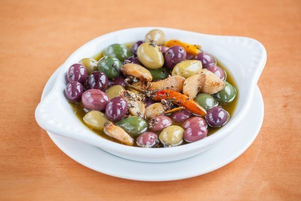 Marinated Olives · Castelvetrano olives, Picholin olives & Gaeta olives marinated in black peppercorn, rosemary, garlic, chili d'arbol, bay leaves, orange rind, lemon rind & extra virgin olive oil.