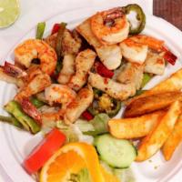 Fajitas De Pescado · Fish fajitas served with grilled onions bell peppers rice, salad and potato wedges