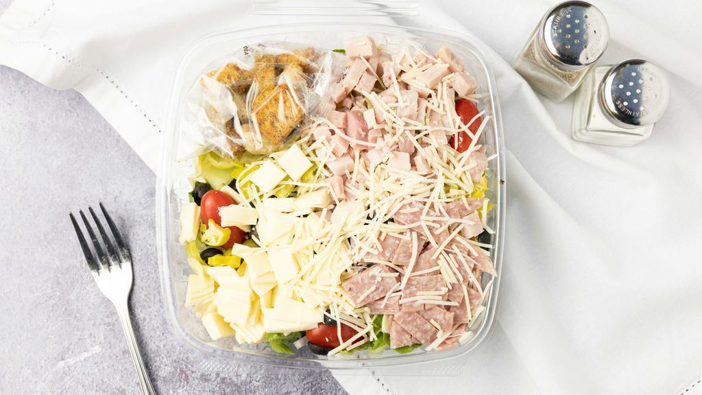 Vince'S Antipasto Salad · romaine lettuce, salami, ham, provolone cheese, 
tomatoes slices, black olives, red onions, pepperoncinis ,Parmesan cheese and croutons.
Come with Italian dressing.