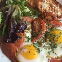 Provençal Eggs · Two organic sunny side-up eggs, fried tomatoes, and provence herbs - sliced bread. No greens.