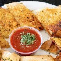 Garlic Bread · Nine inch loaf of perfectly seasoned garlic bread. Served with a side of marinara sauce.