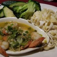 Scampi All'Italiano · Large prawns sautéed in olive oil, butter, garlic and lemon served with fettuccini Alfredo a...