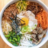 Bibimbap / 비빔밥 · Steamed rice with assorted vegetables and beef.