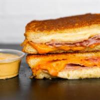 Smoked Ham & Three Cheese Melt · Smoked ham, Cheddar, Swiss, and Parmesan cheeses melted between buttery, toasted sourdough b...