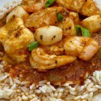 Seafood Creole · Scallops, Shrimp, and White Fish simmered in a spicy red creole sauce on a bed of rice