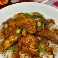 Chicken Étouffée · Chicken Tenders smothered in a rich, roux based creole brown sauce on a bed of rice