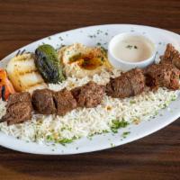Beef Kebab Plate · Skewered cubes of marinated filet mignon charbroiled and served with hummus, rice (pilaf), t...