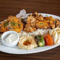 Istanbul'S Chicken Thigh · Marinated, charbroiled chicken thighs, served with hummus, rice (pilaf), garlic sauce, grill...