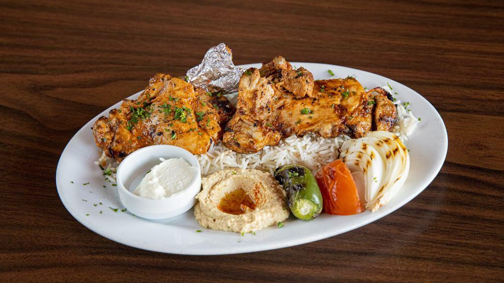 Istanbul'S Chicken Thigh · Marinated, charbroiled chicken thighs, served with hummus, rice (pilaf), garlic sauce, grilled veggies, and pita bread.