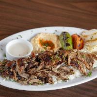 Beef Doner Plate (Shawarma) · Tender marinated beef cooked on an upright split then sliced, served with hummus, rice (pila...