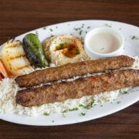 Adana Kebab Plate · Skewered of extra lean ground beef and lamb mixed with parsley, onion, spices are charbroile...