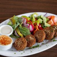 Falafel · Five falafel patties made of chickpeas, served with hummus, tomato, mixed greens, wild cucum...