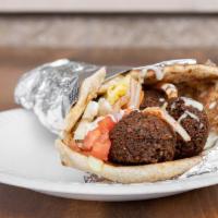 Falafel Wrap · 4 pcs of falafel in a pita bread with lettuce, tomato, onions, and white sauce