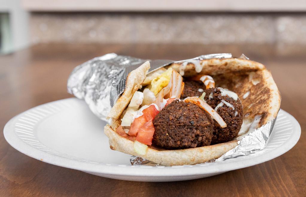 Falafel Wrap · 4 pcs of falafel in a pita bread with lettuce, tomato, onions, and white sauce