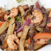 Mar Y Tierra · Beef strips and shrimps sauteed with onions, tomatoes, French fries and served with steamed ...