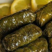 Dolmeh · Grape leaves stuffed with fresh herbs, lentils, beef, and rice.