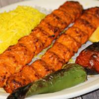 Chicken Koobideh · Ground chicken kabob. Served with grilled vegetables and broiled tomatoes and served with ou...