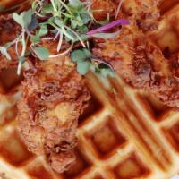 Fried Chicken And Waffles · Belgian waffle topped with buttermilk fried chicken and jalapeño maple syrup.