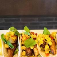 Blackened Fish Tacos · Asian Sea Bass, pan seared and blackened, served on warm tortillas with shredded lettuce and...