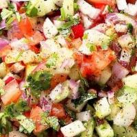 Lentil Kuchumber Salad · Vegan. Gluten-free salad with chopped onions, tomatoes, cucumber, and lentil with lemon-vina...