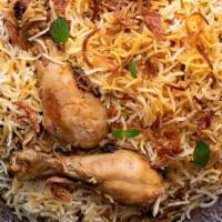 Chicken Biryani · Authentic awadhi bone on chicken biryani, aromatic spices, basmati rice, and side raita.